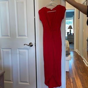 Long red dress, soft material with high middle slit and deep V-cut bodice.
